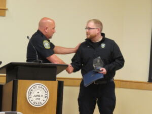 Chief Anderson congratulates Dispatcher Grim after presenting the Life Saving Award.