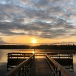 dock in lake at sunset