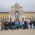 Group posing in front of historic landmark in Portugal