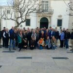 Group photo in front of Portuguese building on Chamber travel tour