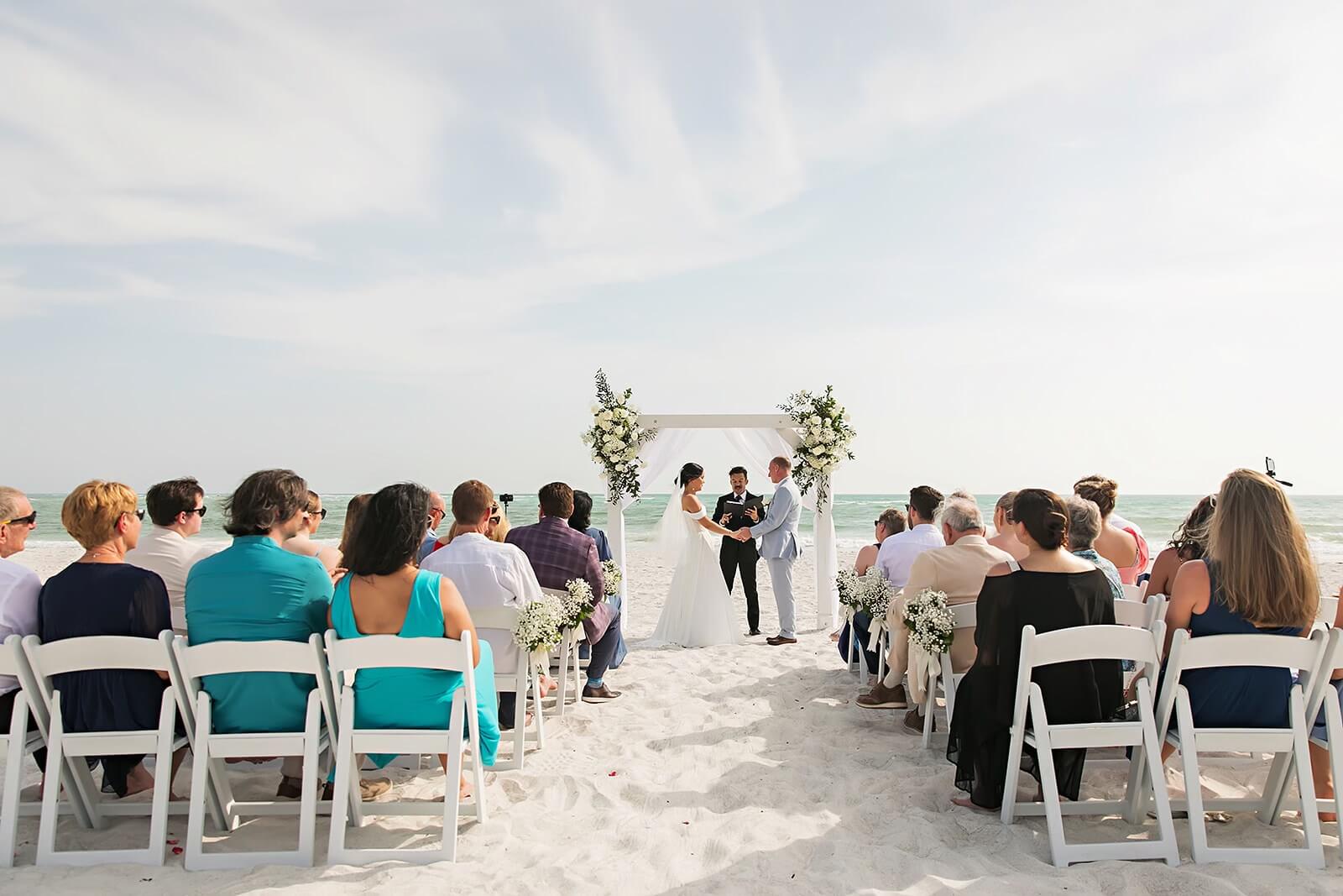 Photo of a wedding ceremony on the beach.