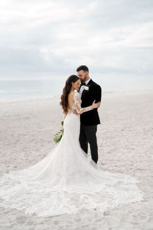 Photo of a couple on the beach on their wedding day.