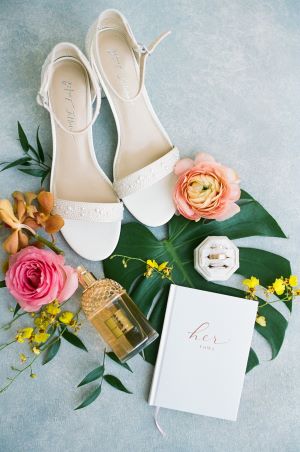 Detail photo of wedding shoes and invitation.