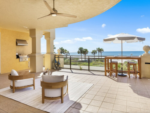 Photo of a large patio with a view of the beach.