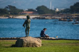 statue overlooking the beach