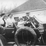 historic photo of family in a car