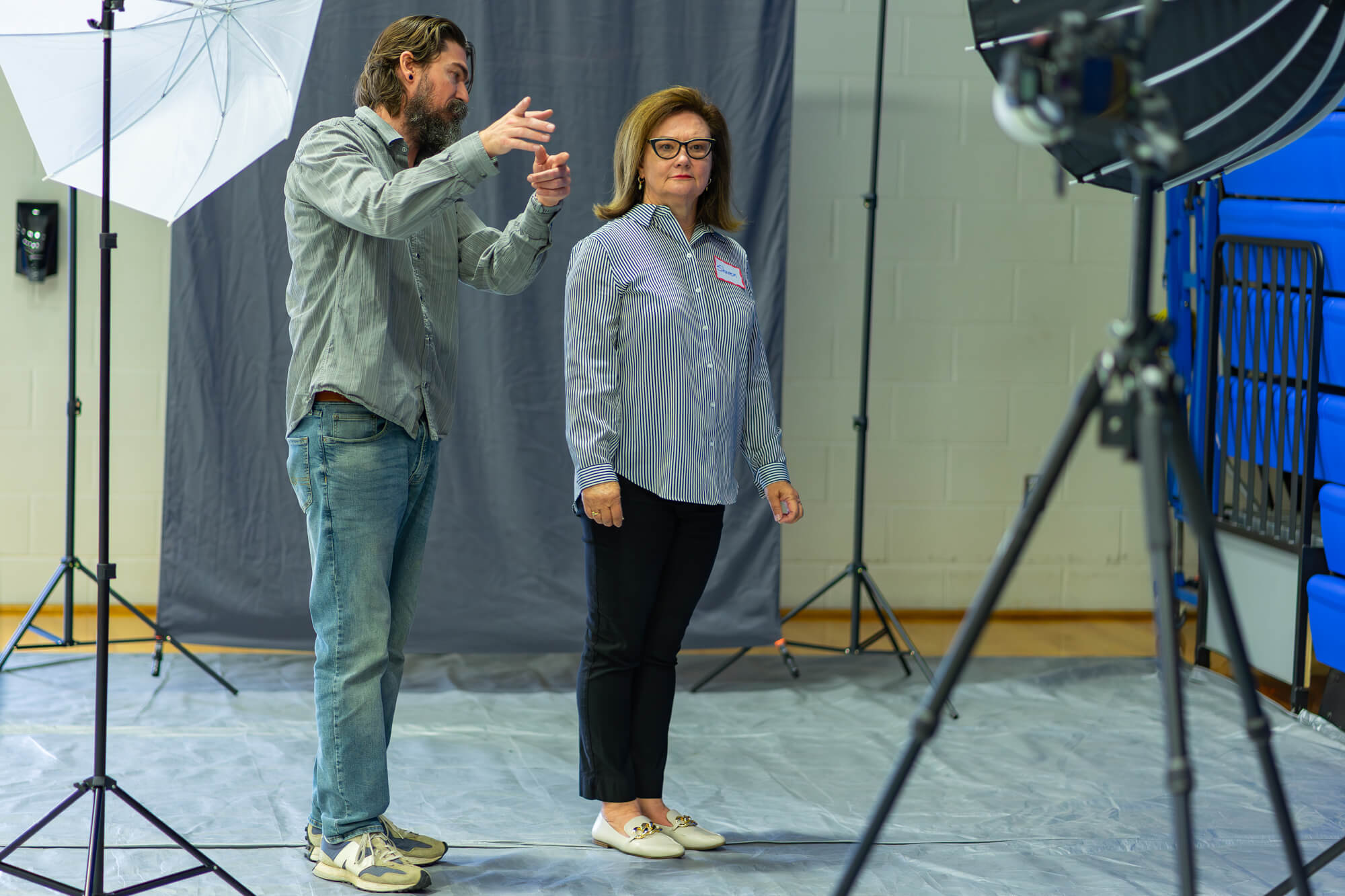 Photographer Redford Lindsey works with a job seeker to capture a professional headshot.