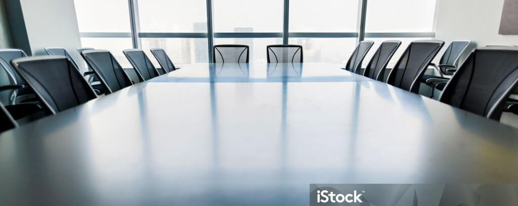 Low angle view of contemporary conference room table and chairs in urban city environment downtown skyscraper high rise above symmetry balance scale