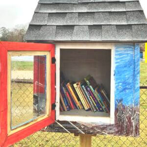 Little library stand with door open and books inside