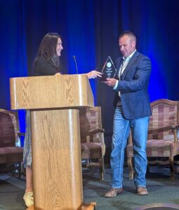 greg williams accepting the impact award for larry clever