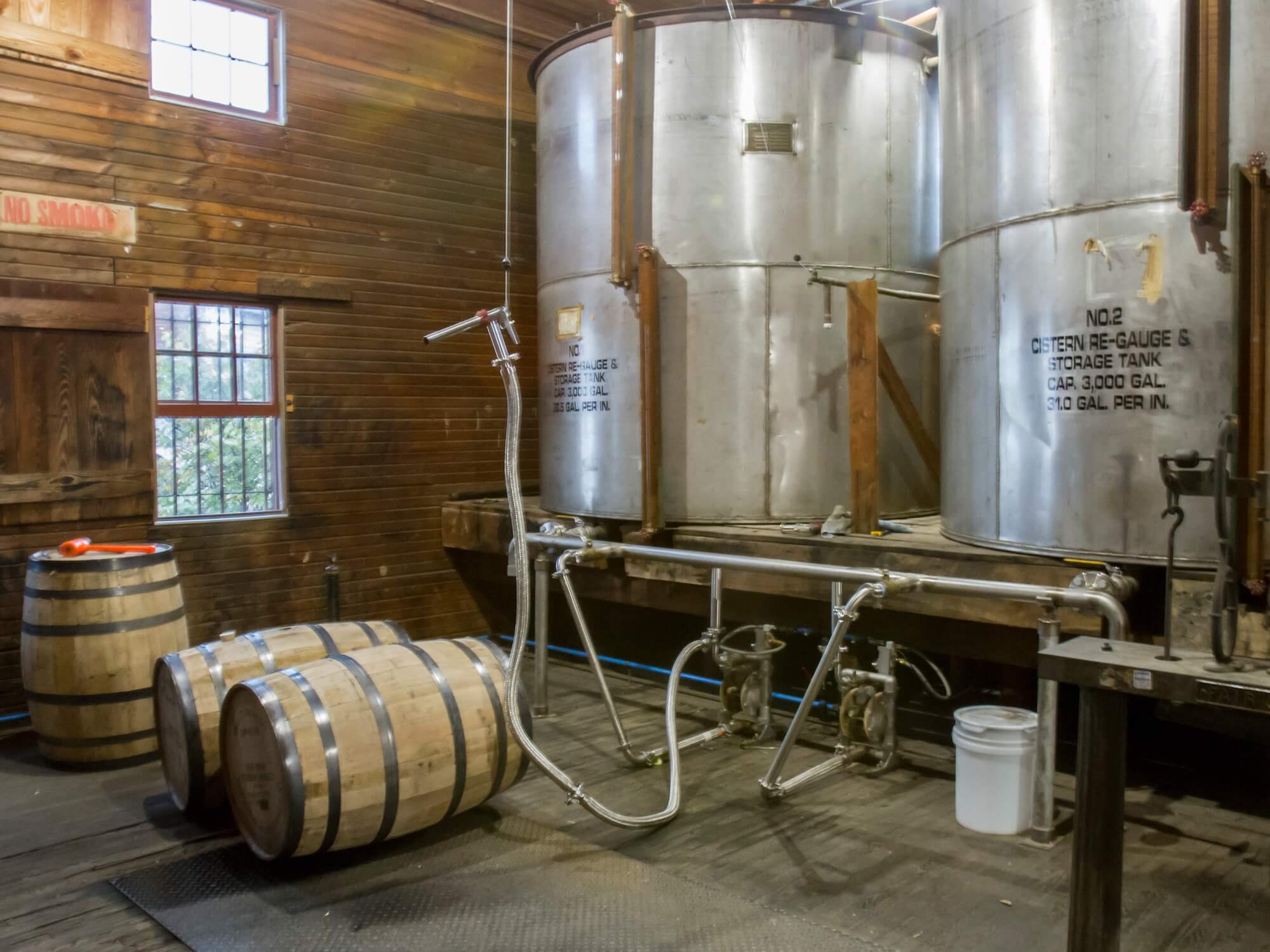 Inside barrel filling room of distillery Barrel filling operations at craft bourbon distillery.