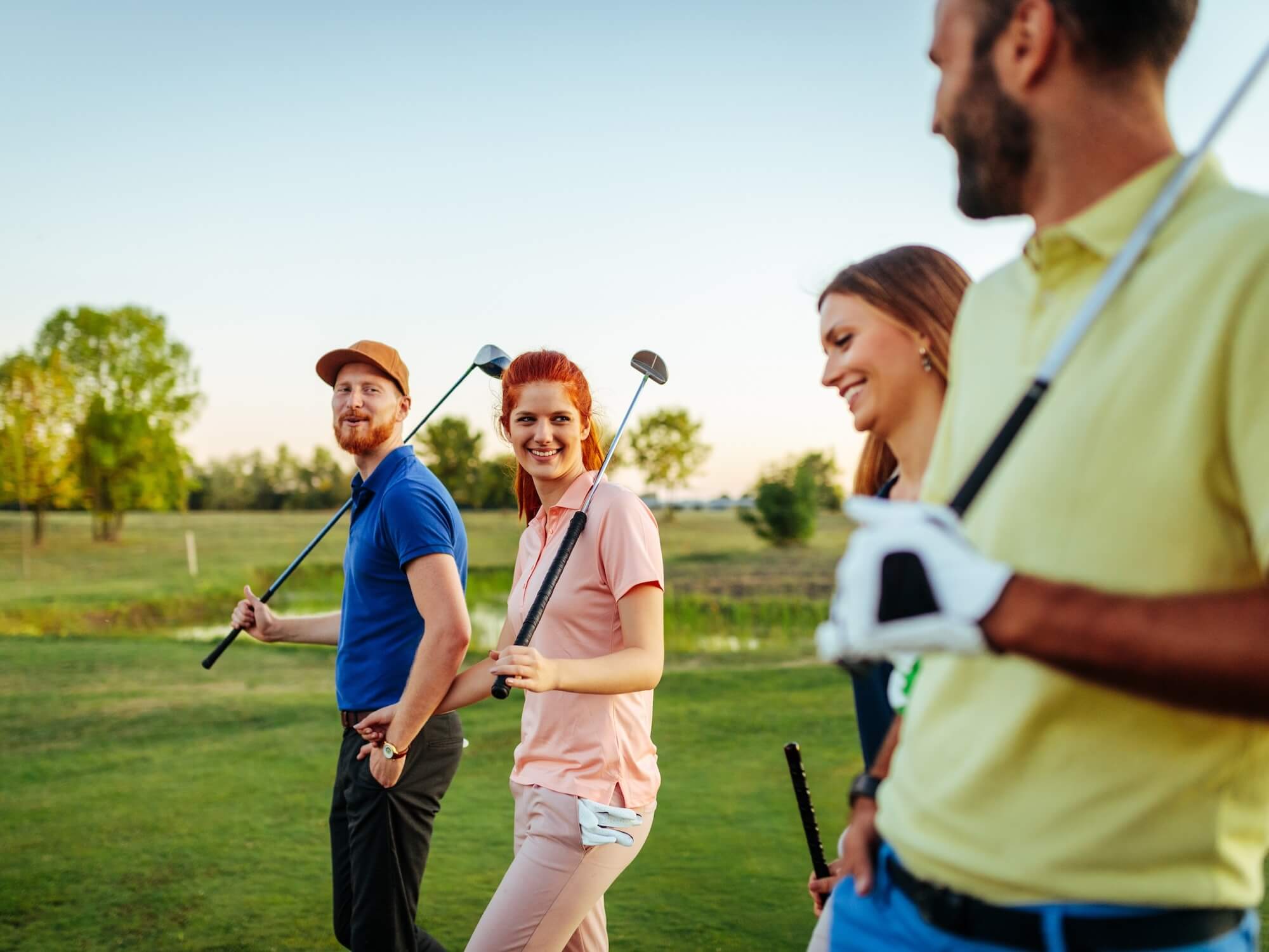 Shot of friends enjoying time on a golf course. Shot of friends enjoying time on a golf course.