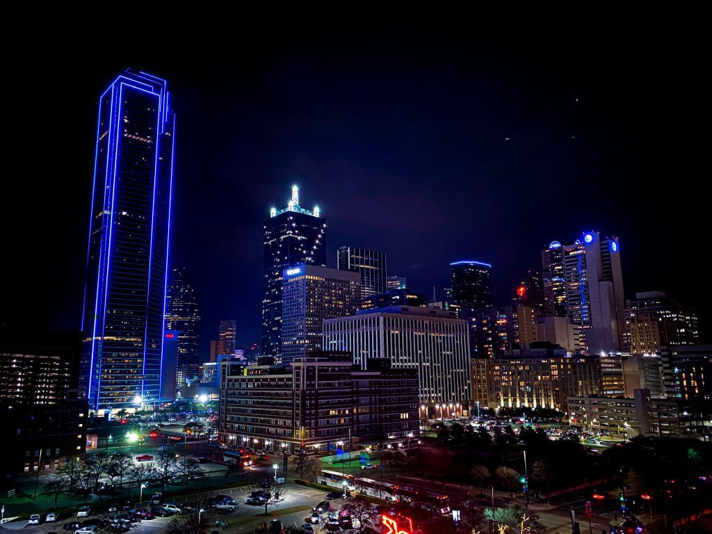 Dallas skyline at night with lots of lights on buildings
