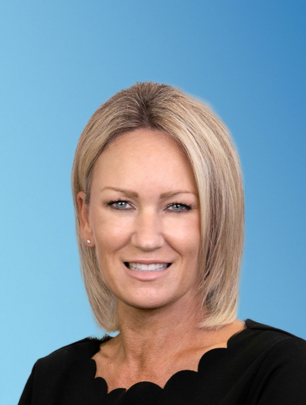 Amanda Hansen - Blue Backdrop Headshot - 03.10.25