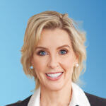 Heidi Mansoori Blue Backdrop Headshot - 04.24.25 Heidi Mansoori Blue Backdrop Headshot - 04.24.25