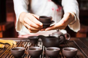 Woman serving Chinese tea in a traditional tea ceremony