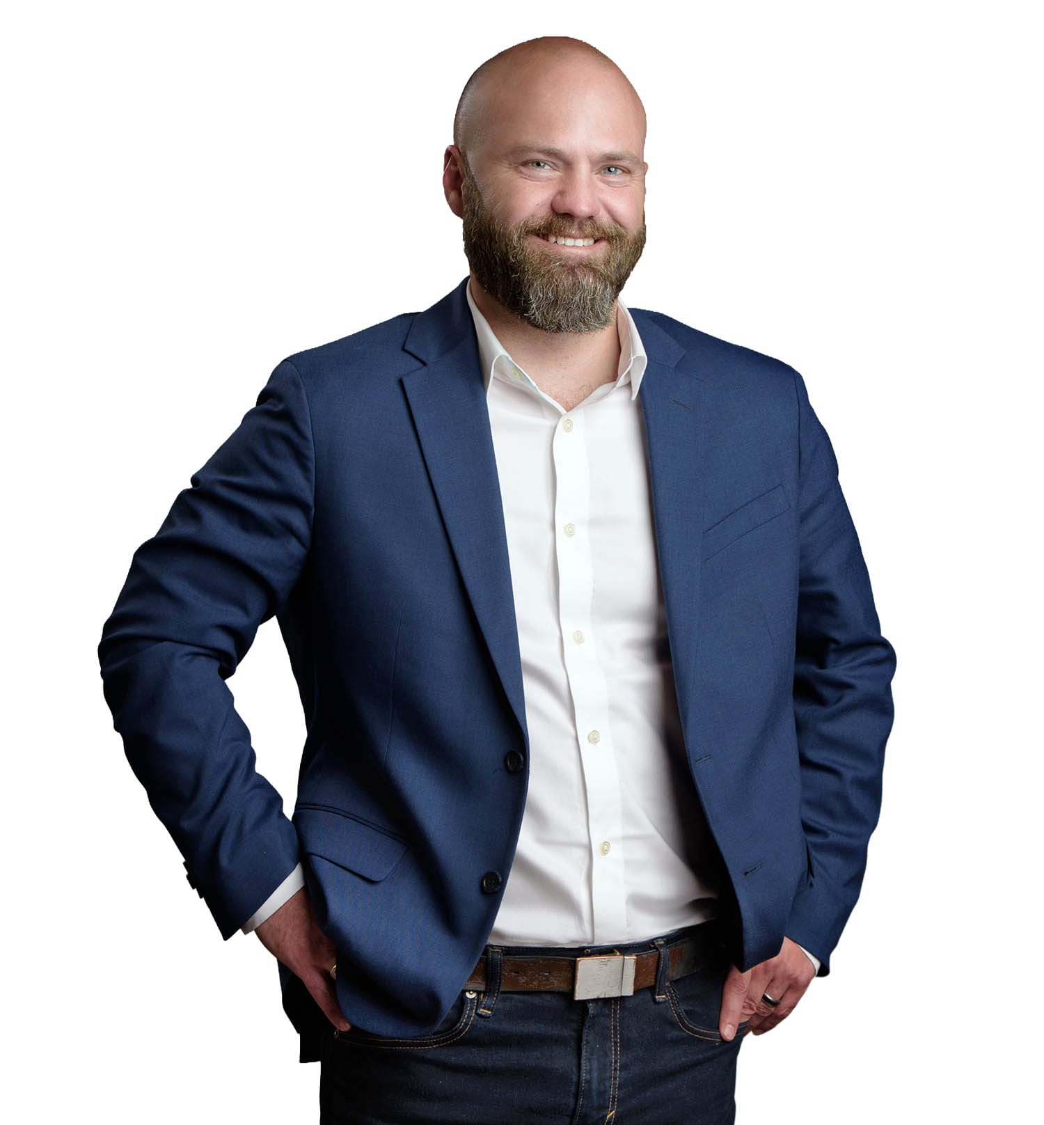 A man stands with his hands at his hips smiling. This is a picture of a Chamber Board Director.