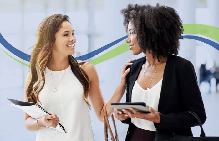 Two payments professionals collaborating with PaymentsFirst to access payments education, ACH support, Nacha Operating Rules guidance, and industry resources for financial institutions and payment providers.