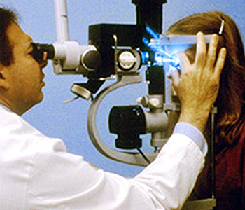 image of eye doctor viewing clients eyes through lens