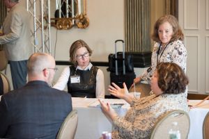 people gathered around a table talking