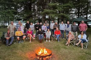 group photo around campfire