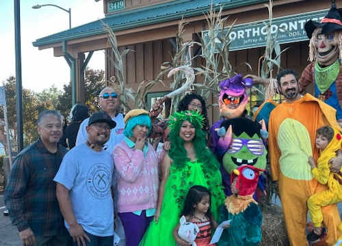 family dressed in costumes smiling