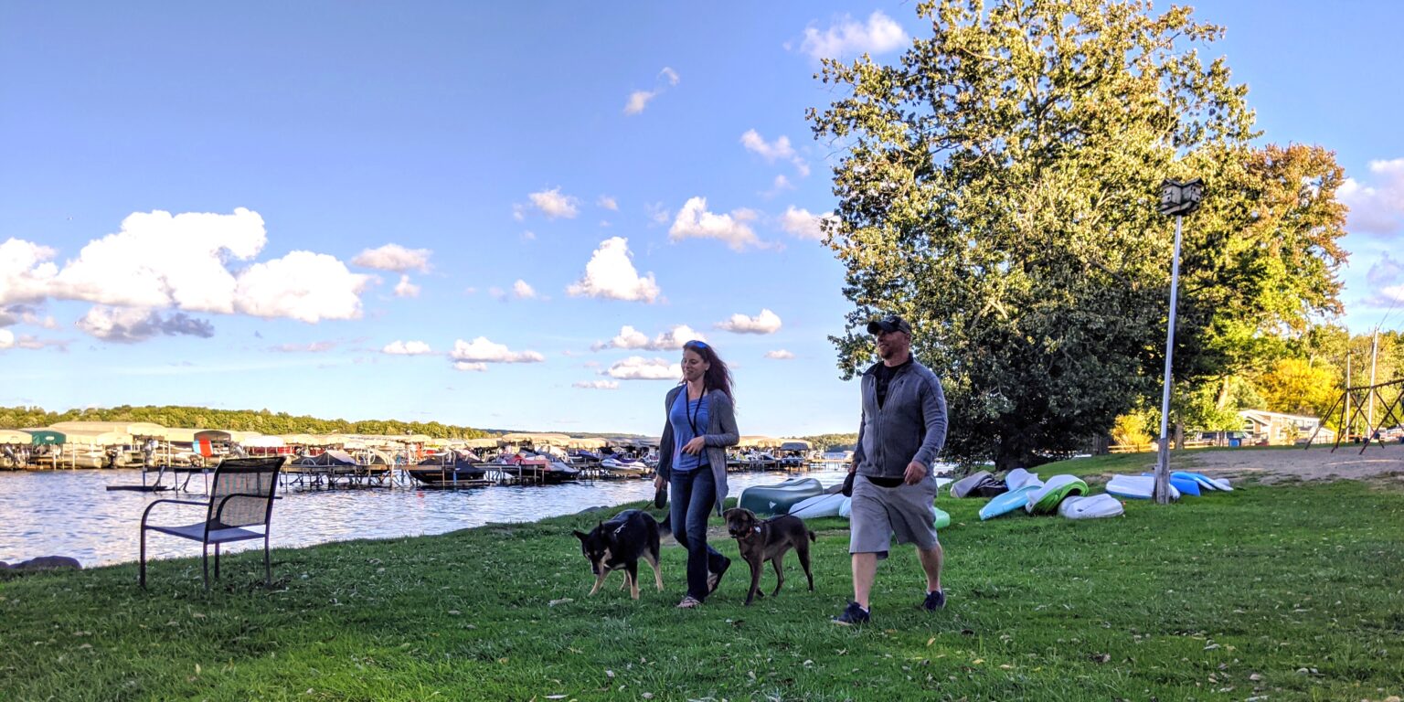 Couple walking Lakeside with dog