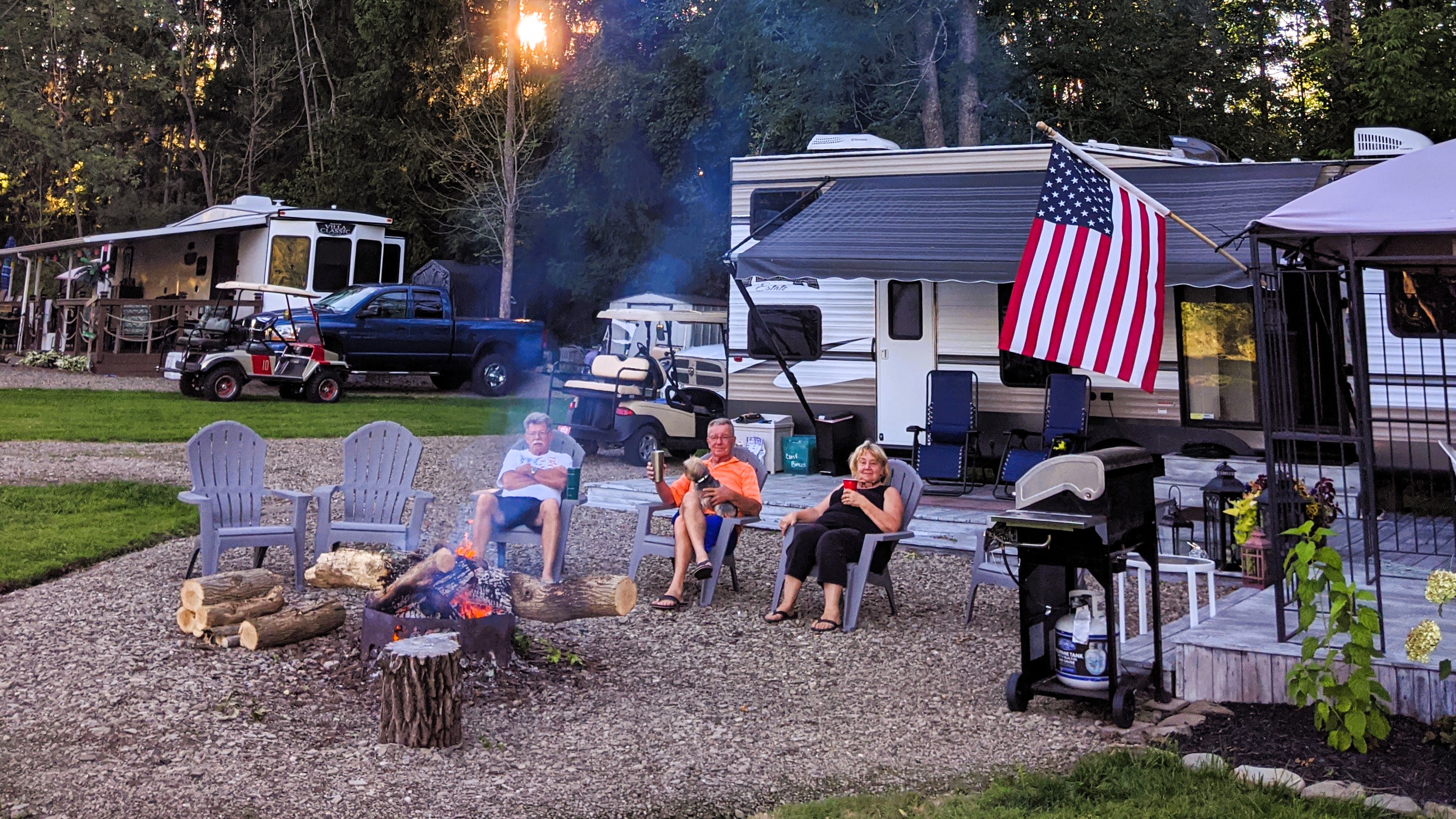 People sitting around a fire, camping,