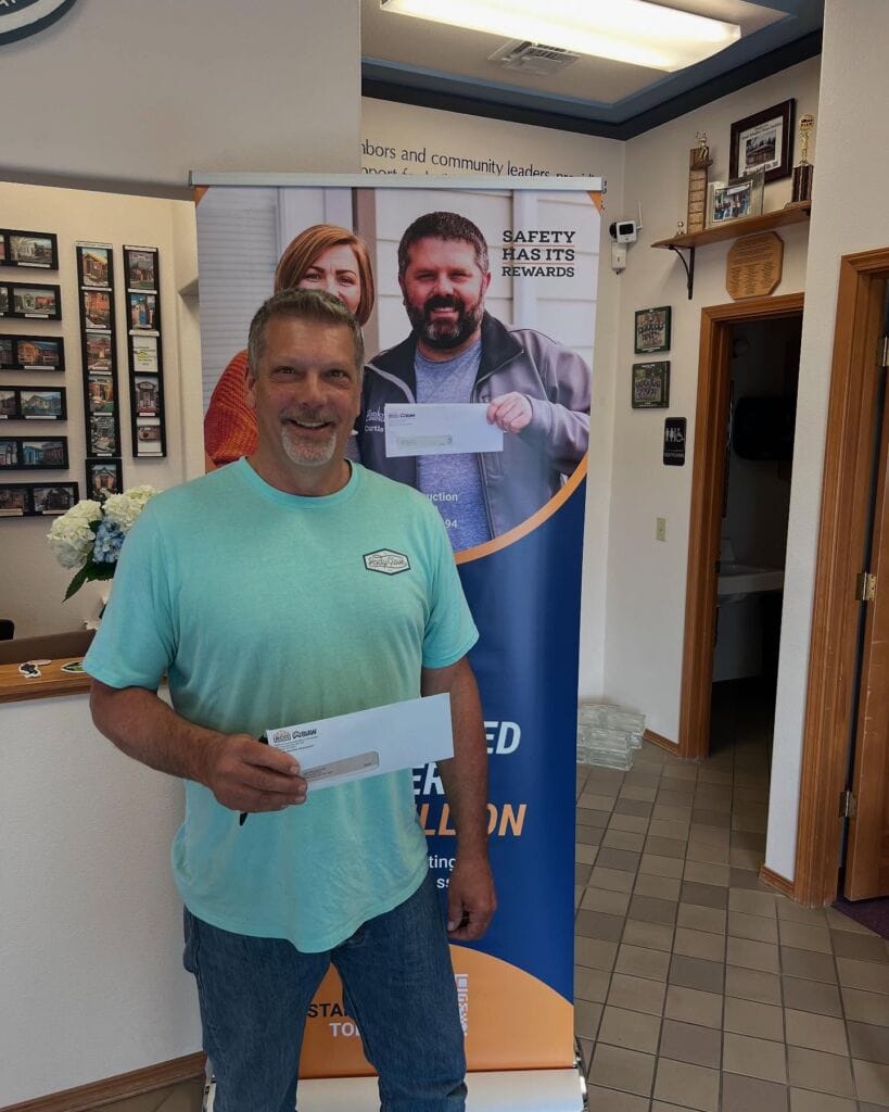 ROII participant receiving a rebate check from a fellow SICBA member at the Return Check Party