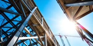 Steel beams connecting, forming a building frame.