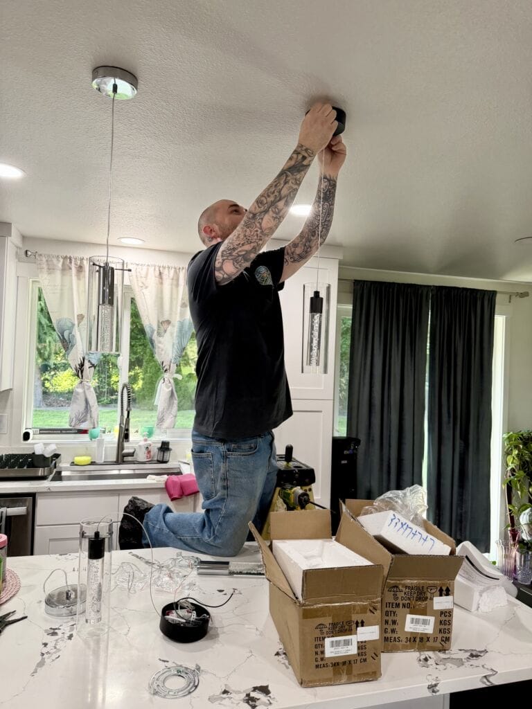 Electrical contractor installing recessed lighting during kitchen remodel in Skagit Valley