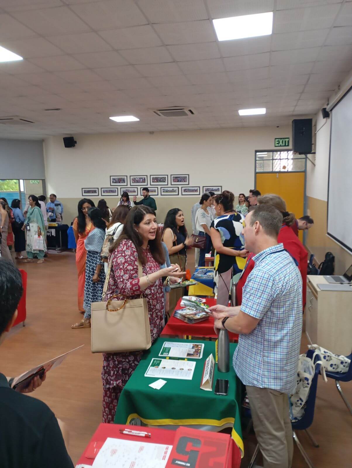 People talking across a table of information about college.