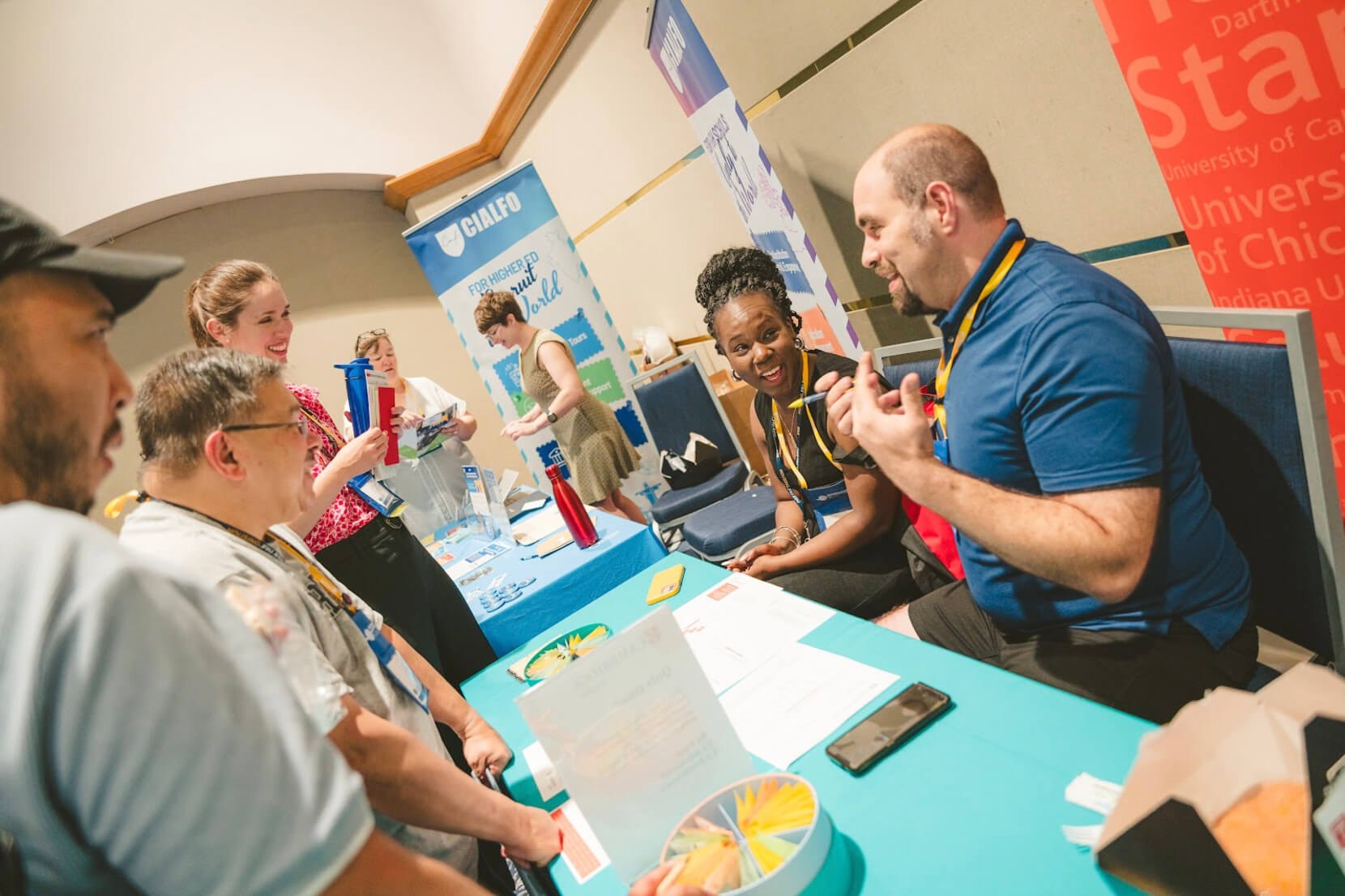 People talking over a table at the Exhibit Hall