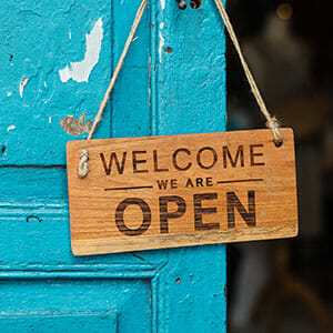 "welcome we are open" sign