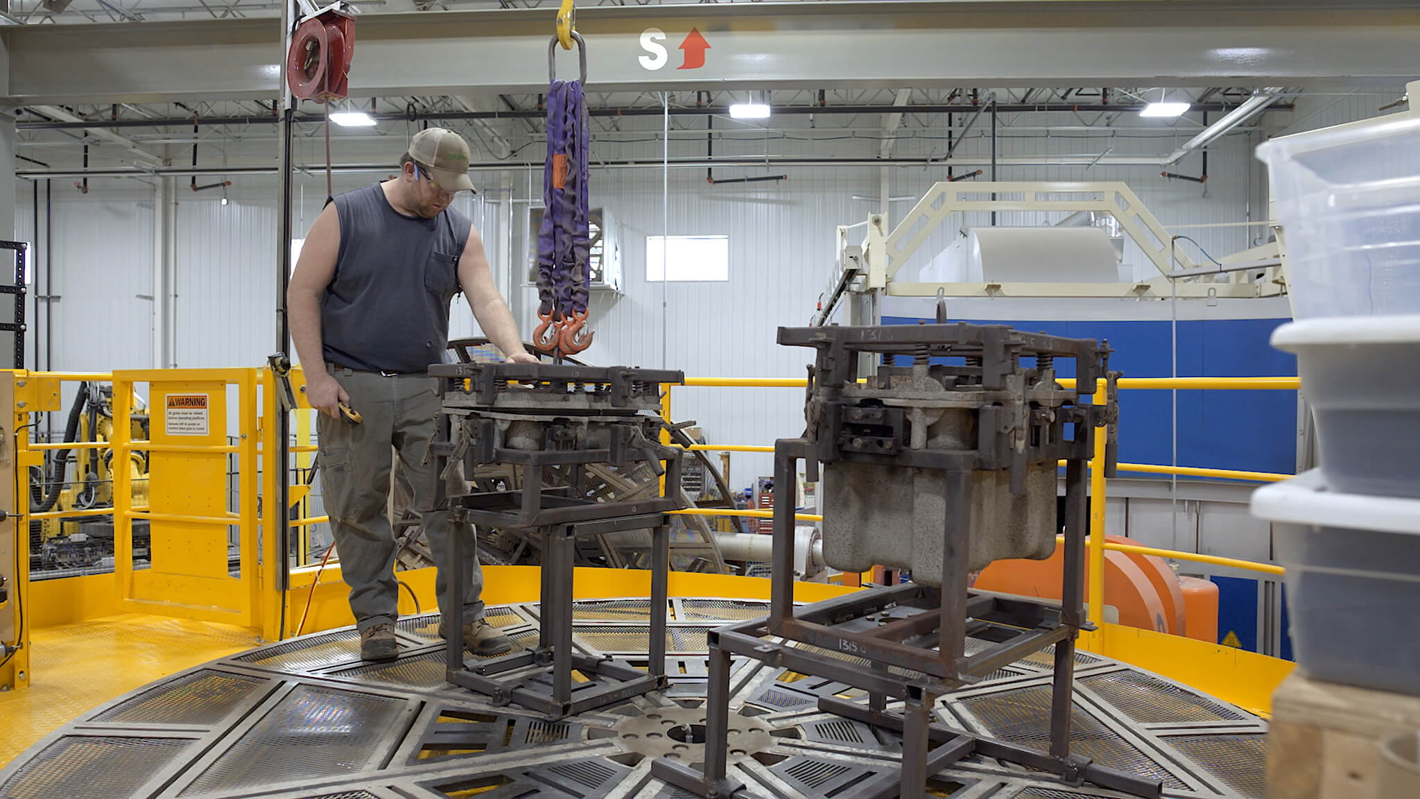 still from Modern Manufacturing video showing a man operating a machine