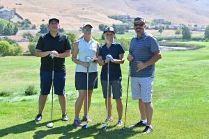 4 people playing golf