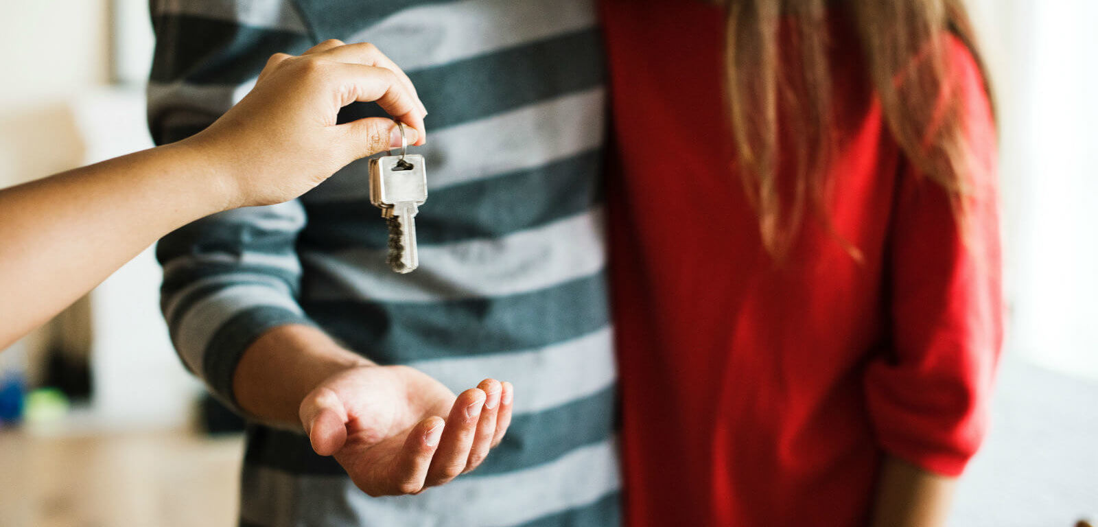 handing keys to a couple