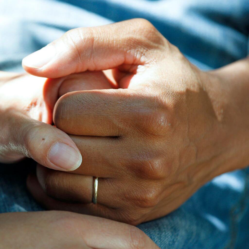 holding hands in hospital setting