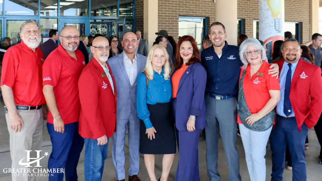 Business and community representatives stand united at an event, emphasizing business resilience in Harlingen.