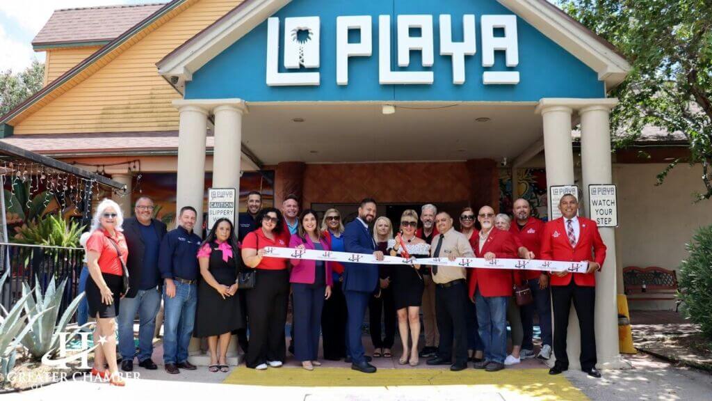 Greater Chamber of Harlingen staff celebrating a ribbon-cutting with a member business to enhance community credibility and consumer confidence.
