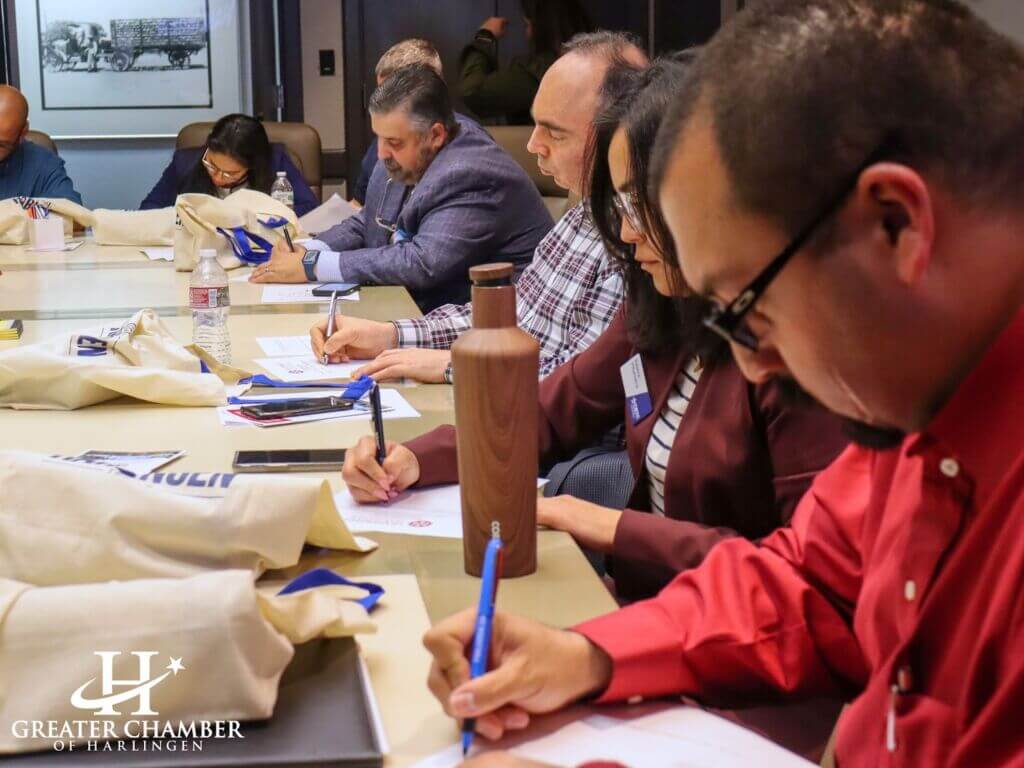 Leadership Harlingen participants take notes during a session, highlighting active learning, collaboration, and community focused leadership development throughout the program.