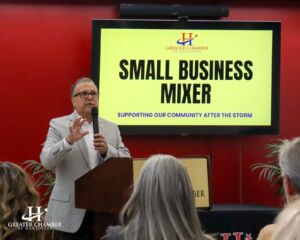 Chamber president giving guidance during a community meeting, aligning programs and initiatives with member needs