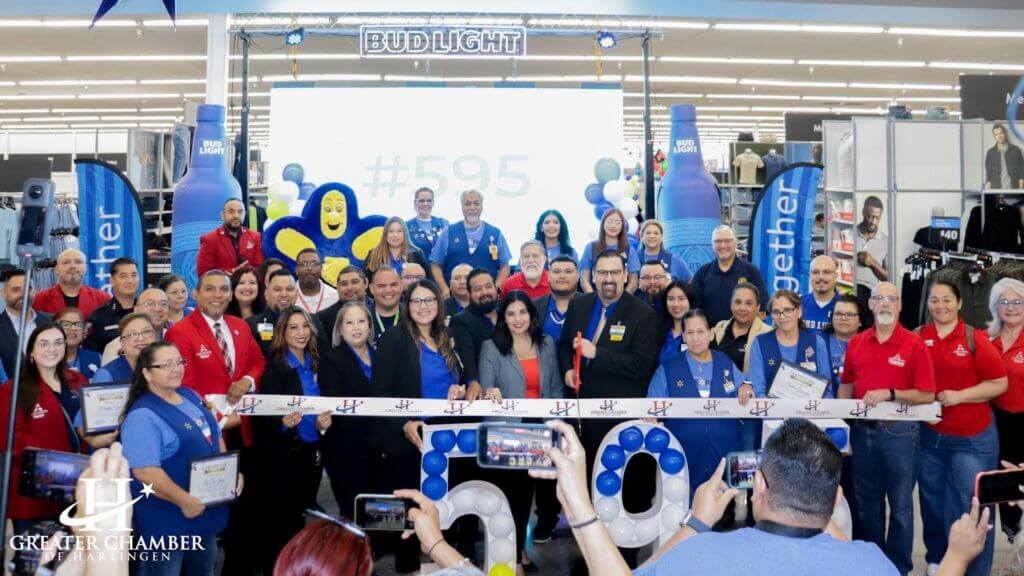 Chamber staff and members celebrating a ribbon-cutting ceremony to enhance visibility and community engagement.