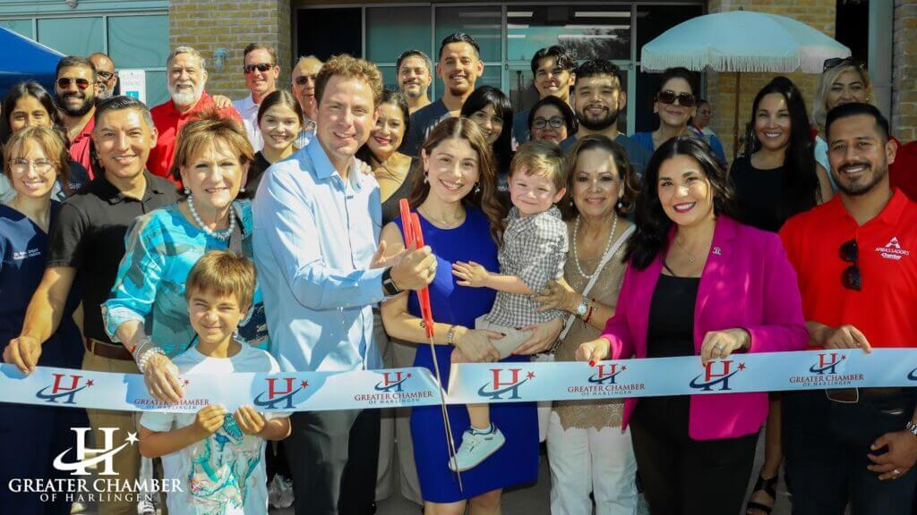 Ribbon-cutting ceremony with local families and business leaders celebrating new ventures in the Harlingen business community, supported by the Greater Chamber of Harlingen.