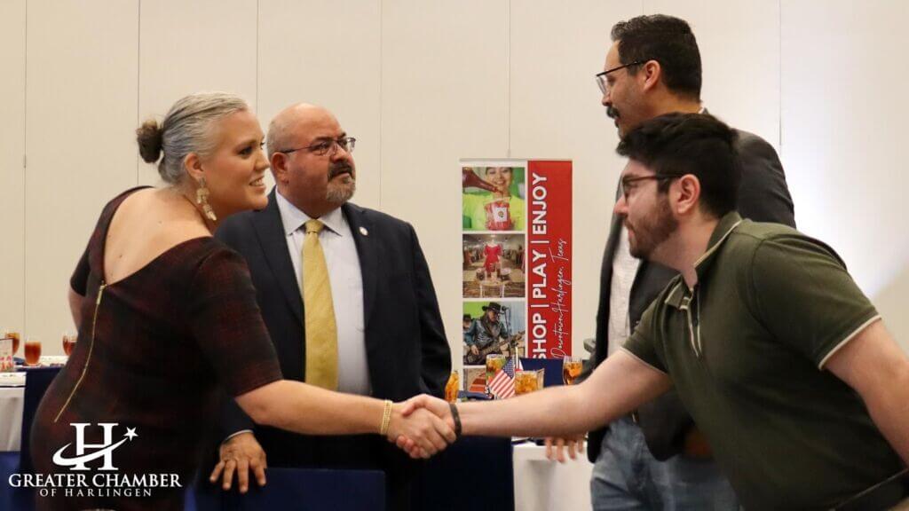 Guests greet one another at a Greater Chamber of Harlingen event, with members exchanging handshakes and conversation