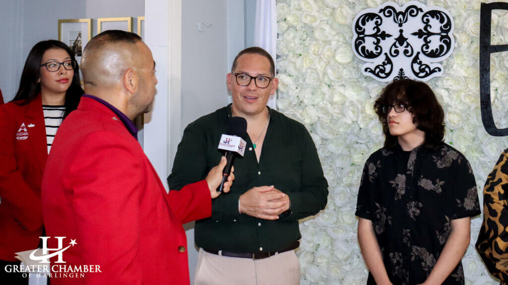 A Chamber representative interviews an event attendee during an event, showing support and camaraderie.