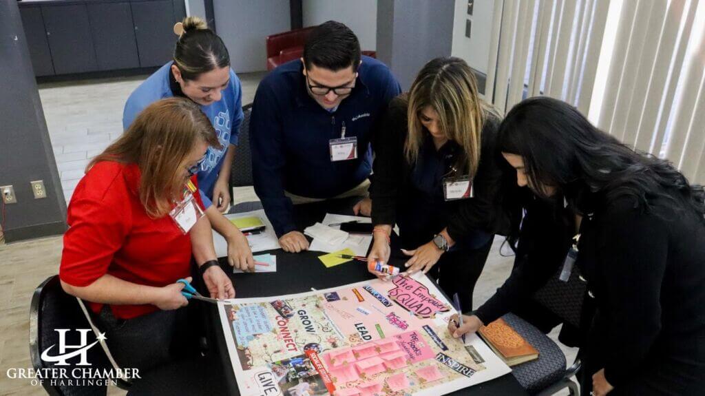 Leadership Harlingen Class XXXVIII participants gathered around a table during a team building activity, highlighting the collaborative spirit that strengthens Harlingen events and community leadership.