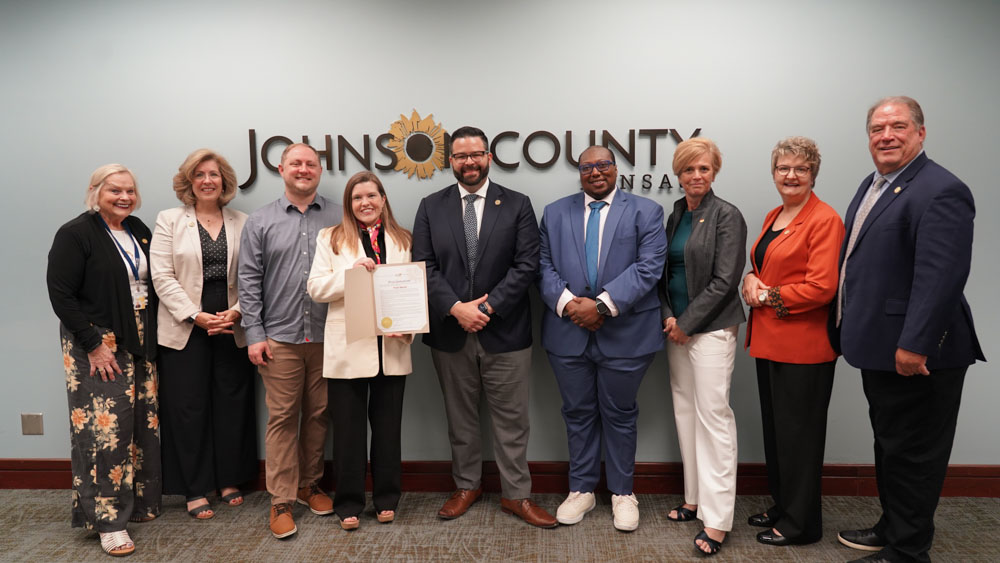 joco proclamation 2025 Left to right: Commissioner Shirley Allenbrand (6th District), Commissioner Julie Brewer (3rd District), Chamber Board Member Zach Rose-Heim, Chamber Board President Kate Nielsen, Johnson County Board Chair Mike Kelly, Chamber Board Vice President Jay Bohanon, Chamber Executive Director Tracey DeMarea, Commissioner Janee Hanzlick (4th District), and Commissioner Jeff Meyers (2nd District) pose for a photo following the official proclamation of June 2025 as Pride Month in Johnson County.