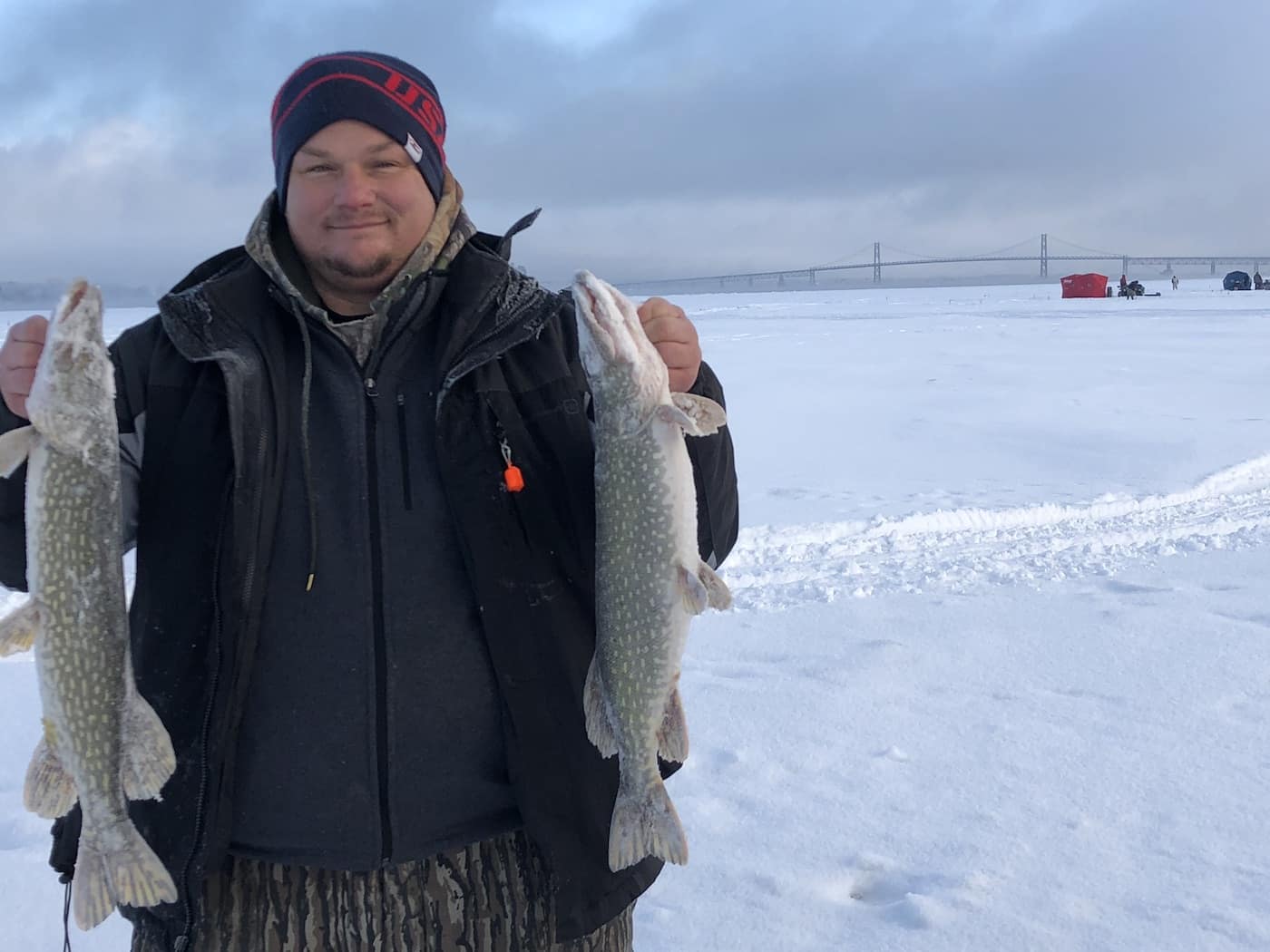 ice fisherman holding fish