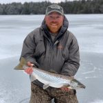 ice fisherman holding fish